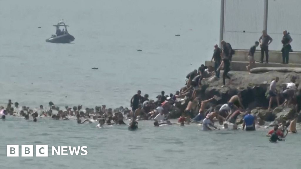 Migrants seen swimming around border fence of Spanish enclave Ceuta